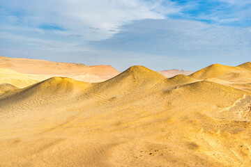 Desert dunes stretch across the arid landscape of Paracas National Reserve in Peru.