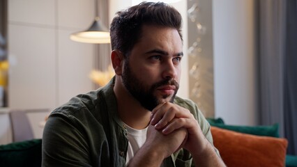 Nervous thoughtful Caucasian business man male guy client homeowner businessman sitting sofa folded...