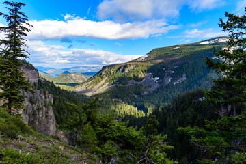 Mountains in the snow, overgrown with wood. Thick clouds over the mountains. Montana, USA