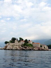 Stunning Views of Sveti Stefan Island Resort in Montenegro Under a Cloudy Sky