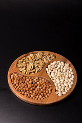 Tree minazhnitsa with walnuts, hazelnuts, pistachio on a black background