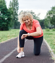 Portrait of a mid age mature sport woman smiling happy and confident, prepering for jogging and run...