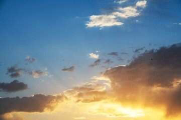 Beautiful bright sunset sky background with clouds.  Evening time.