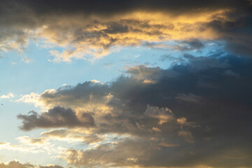 Beautiful bright sunset sky background with clouds.  Evening time.