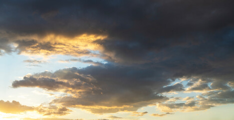 Beautiful bright sunset sky background with clouds.  Evening time.