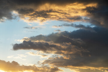 Beautiful bright sunset sky background with clouds.  Evening time.