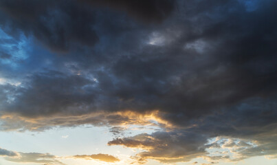 Beautiful bright sunset sky background with clouds.  Evening time.