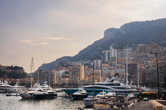 MONACO, MONACO &ndash; JULY 26, 2024: Luxury yachts and superyachts are moored in Port Hercules harbor against the backdrop of the Monaco cityscape.