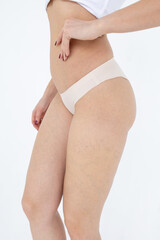 Beige women's briefs on the model. a woman in beige body shorts