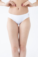 Beige women's briefs on the model. a woman in beige body shorts