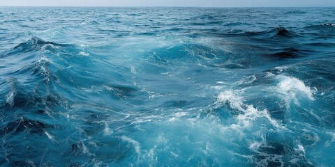 Fototapeta premium Vibrant ocean waves with crisp blue water under clear sky