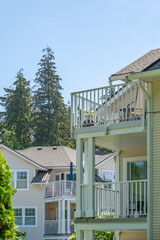 Top of modern apartment building with balcony, trees and beautiful landscape in Vancouver, Canada, North America. Day time on June 2025.