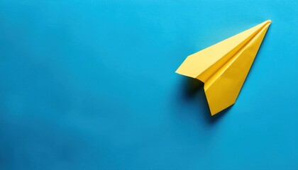 Yellow Paper Plane on Blue Background - Symbolizing Success in Business Growth