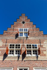Historic house with shutters and step gable in Den Bosch, Netherlands