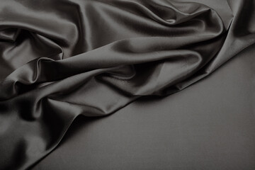 Black pearl wave fabric silk. Abstract texture copy space background.