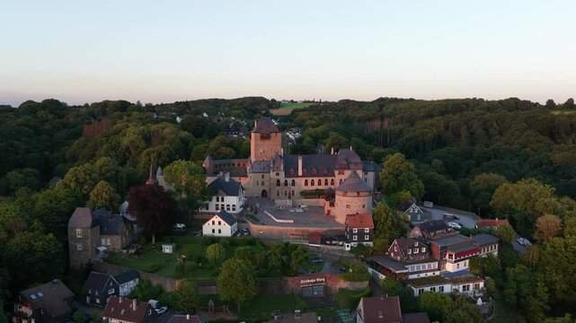 Schloss Burg, castle in Sollingen, overlooking the river Wupper, Medieval castle in the german hills. Aerial video at sunset