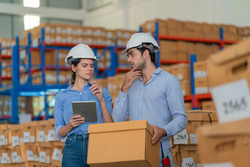 Warehouse worker working in warehouse storage. Foreman or worker work at factory site check up...