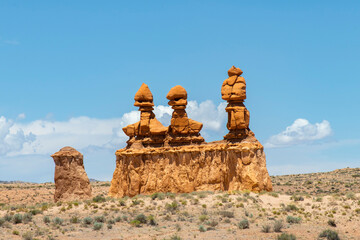 Mushroomlike sandstone rock formations called goblins and eroded cliffs in Goblin Valley State...