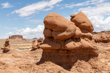 Mushroomlike sandstone rock formations called goblins and eroded cliffs in Goblin Valley State...
