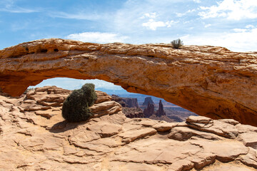 The pothole Mesa Arch (or Rotary Arch and Trail Arch) on the Island in the Sky mesa in Canyonlands National Park, Utah, with views of canyons and the La Sal Mountains in the distance