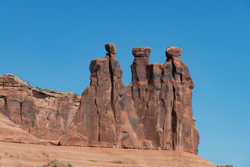 Close up of landmark geological formation Three Gossips against a blue sky in Arches National Park, Moab, UT, USA