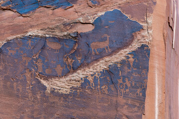 Close up of some of the petroglyphs high up on the cliff face of the geological sandstone formations along the Potash Road and Colorado River near Moab, Utah, USA