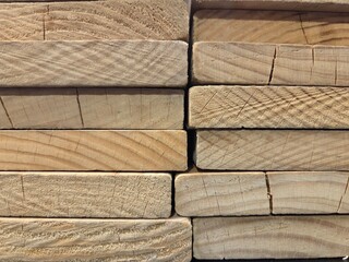 Stacked wooden planks for construction and carpentry projects. Horizontal banner. Copy space