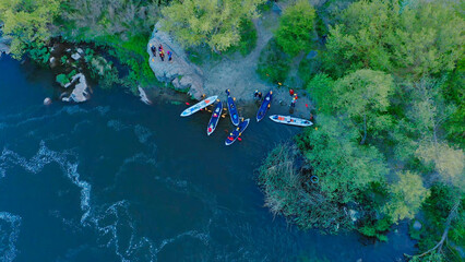 Aerial view of the winning rowers disembarking from boat races on the river. © monvideo