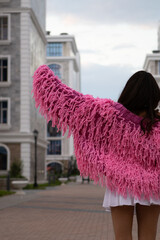 Woman in Pink Knit Cardigan with Fringe, Fashion Trend