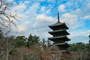 Magnificent five-story wooden pagoda of Ninna-ji Temple towers above the surrounding bare winter...