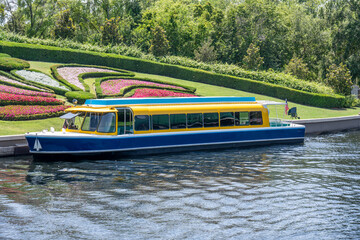 small passenger boat moored at the side of a river bank