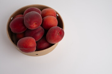 Bowl of fresh ripe apricots on light background. Fresh fruits and vitamins