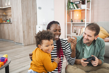 A multiracial family enjoying time together in their cozy living room