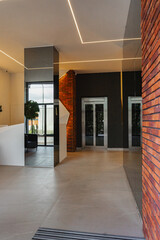 Obraz premium Interior of a building corridor with stairs and elevator