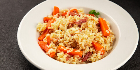 Rice meat and vegetables pilaf fresh delicious gourmet food background on the table rustic food top view copy space