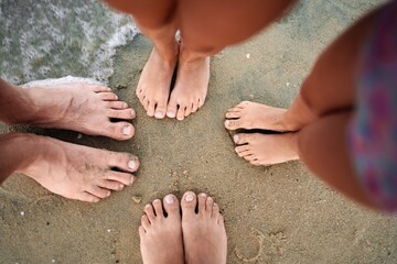 Family bonding at the beach with toes in the soft sand