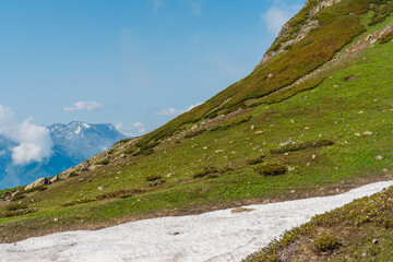 Gorgeous landscape in the mountains with snow-capped hills and clouds over the peaks of the mountains, Sochi, Krasnaya Polyana
