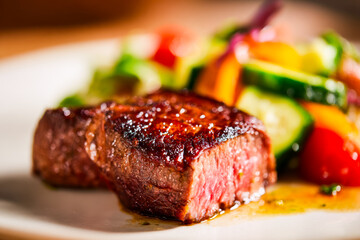 Juicy grilled beef steak with fresh vegetable medley