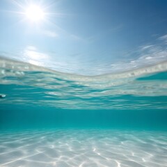 Obraz premium Underwater View: Sunlit Ocean Surface and Sandy Seabed with Clear Blue Water