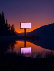 Vibrant sunset with an illuminated billboard reflected on calm water at dusk