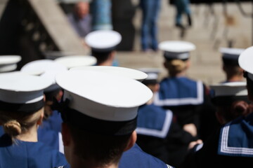 Navy sailors in uniform with their backs to camera Uniformed Heads and Hats from Behind: Naval Style