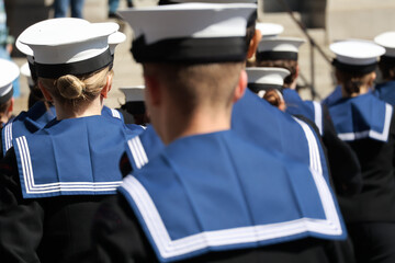Navy sailors in uniform with their backs to camera Uniformed Heads and Hats from Behind: Naval Style