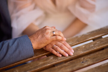 A Romantic Wedding Couple Holding Hands in Their Elegant Attire, Radiating Joy and Love