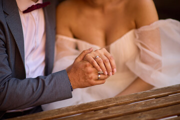 A Romantic Wedding Couple Holding Hands in Their Elegant Attire, Radiating Joy and Love