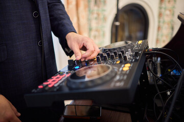 Witness the DJ mixing equipment performing live and in action at a vibrant music event
