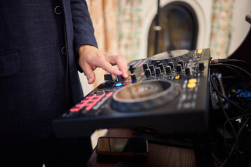 Witness the DJ mixing equipment performing live and in action at a vibrant music event