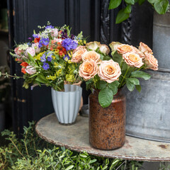 A Rustic Display of Fresh Flowers in Vintage Vases.