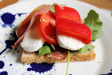 Salami, mozzarella, tomatoes , red pepper and prosciutto on toasted bread