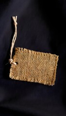 Burlap tag mockup branding identity design template on dark background close up view
