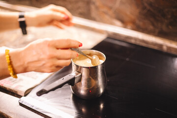 Woman brewing coffee on a stove